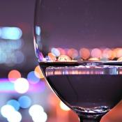 Close up of wine glass with city in background